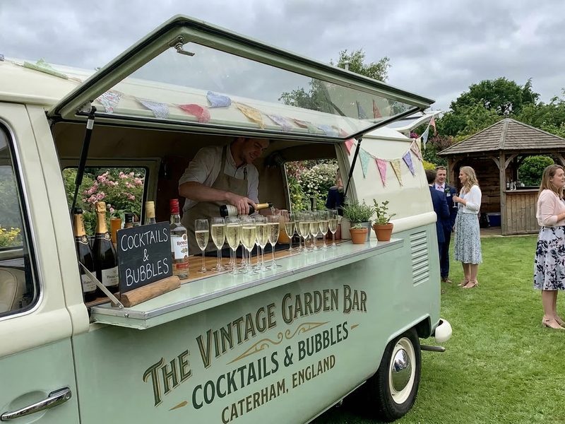 A cocktail van serving drinks at an outdoor wedding reception