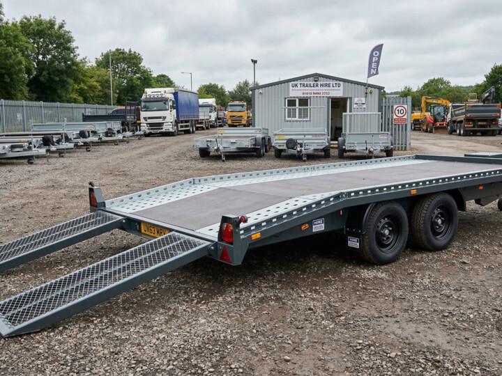 Beavertail car transporter trailer with loading ramps down in a UK hire yard